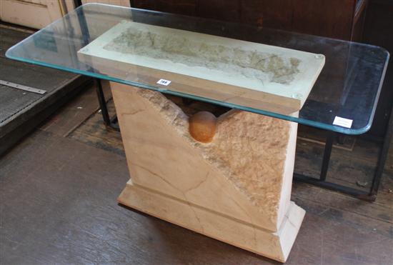 Glass topped coffee table with stone base